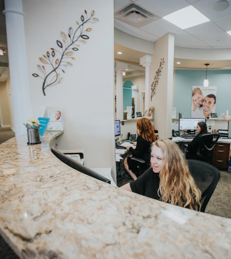 Dentist Biddeford ME Front Desk Assistants Working Behind the Reception Desk Front Desk Assistants Working Behind the Reception Desk